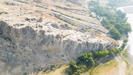 Archaeological site with the remains of a rock-cut settlement dating back to the Iron Age.