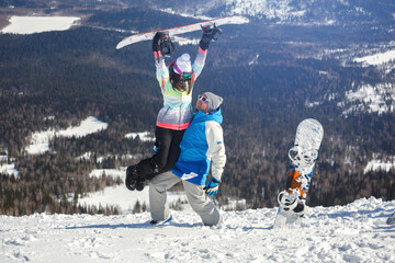 Young couple having fun with snowboards.