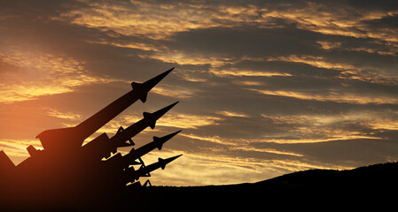 The missiles are aimed to the sky at sunset. Nuclear bomb, chemical weapons, missile defense, a system of salvo fire.