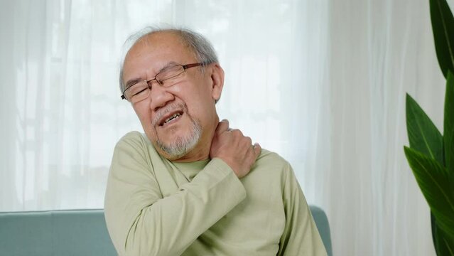 Close up of sad senior man neckache hand holding neck, old man suffering from nape neck pain at home, Elderly acute neckaches, Old age retirement health problems unhealthy diseased, healthcare
