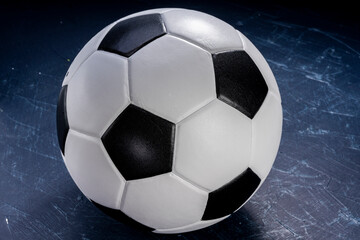 Naklejka premium Football ball on black background, Football ball sports equipment on dark wooden background.