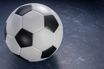 Football ball on black background, Football ball sports equipment on dark wooden background.