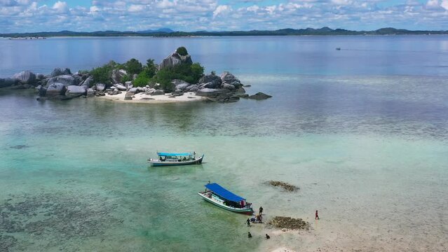 aerial of traditional indonesian boats anchored in low tide at lengkuas island in belitung