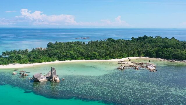 aerial of rocky coastline on remote tropical island in turquoise water at belitung indonesia