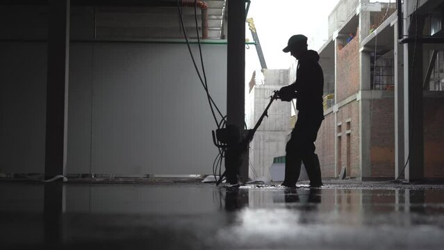 Levelling concrete floor. Construction work inside of giant warehouse