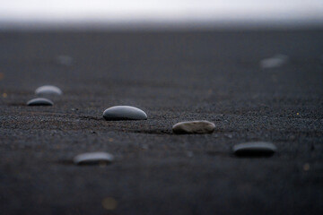 Rocks at Reynisfjara , black sand beach Basalt Column and  Reynisdrangar during winter cloudy day near Vik , Seafront village in South Coast of Iceland : 20 March 2020