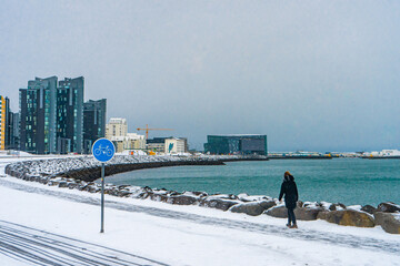 Nice view and buildings next to the Sæbraut road on the shore of Reykajavik during winter cloudy...