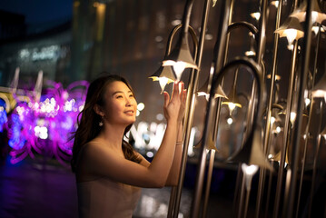 Fototapeta na wymiar asian young women Celebrate the new year, colorful lights, Christmas