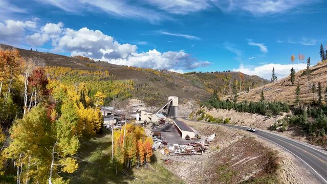 Aerial coal mine autumn mountains Utah fast. Extracting coal from ground. Tunneling, digging, deep underground.  Environmental impacts, pollution, global warming, climate change energy use.