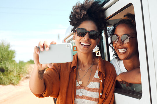 Selfie, smile and friends on a road trip with a car during a safari holiday in Kenya. African women with phone for photo, communication and social media live streaming on vacation in the desert