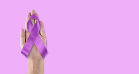 Purple awareness ribbon for World cancer day and World Alzheimers day (month) concept, bow on helping hand support isolated