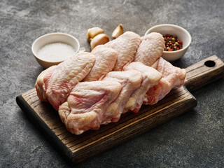 Raw chicken wings Poultry meat with spices, salt and pepper, on gray background