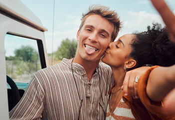 Selfie, kiss and couple taking a picture on a road trip, having fun on a traveling adventure...