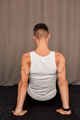 Obraz premium The back of a athlete. Muscles on the hands. Rear view. Fitness Yoga Pilates