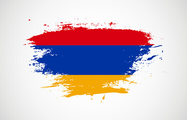 Grunge brush stroke with the national flag of Armenia on a white isolated background