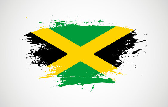 Grunge brush stroke with the national flag of Jamaica on a white isolated background