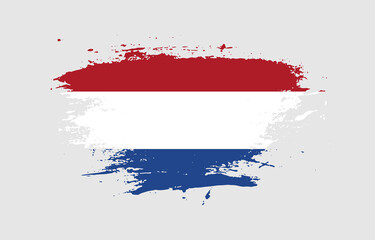 Grunge brush stroke with the national flag of Netherlands on a white isolated background