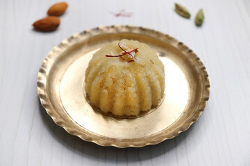 Rava Sheera or Suji ka halwa, shira is an indian sweet dish, made with semolina, sugar, ghee and dry fruits. served as dessert or as Prasad during festivals. Garnished with saffron. Copy space.