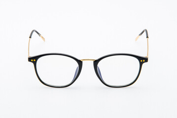 Fototapeta premium Fashion sunglasses black and gold frames on white background.