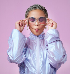 Fashion, beauty and lips with a black woman or model in sunglasses pouting in studio on a pink background. Trendy, style and edgy with an attractive, goofy female posing in contemporary clothes - obrazy, fototapety, plakaty