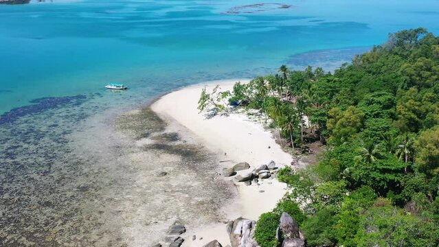 aerial of white sand beach with large boulder rocks in belitung indonesia