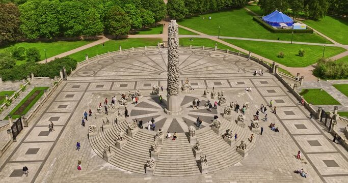 Oslo Norway v44 cinematic low level birds eye view drone fly around the remarkable centerpiece monolitten sculpture with tourists visiting famous frogner park - Shot with Mavic 3 Cine - June 2022