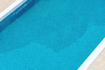 High angle view of empty outdoor swimming pool on summer day