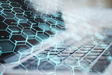 Close up of laptop with creative blue hexagonal background. Technology, communication and network concept. Double exposure.