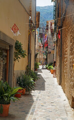 Fototapeta na wymiar Narrow Street in Soller Mallorca with decorations including Dream catcher.