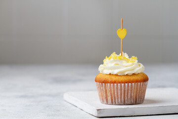 Cupcake with yellow heart close-up