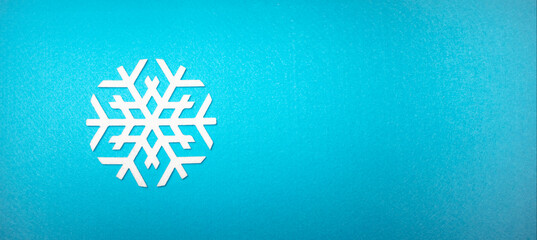 A white snowflake on a blue felt fabric. Blue background with snowflake for text. New Year's...