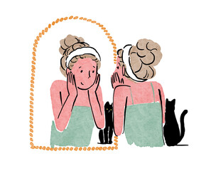 鏡の前で肌のお手入れをする女性