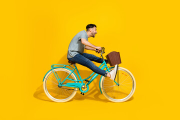 Side profile photo of young active energetic man driving new retro bicycle legs up crazy hurry fast...