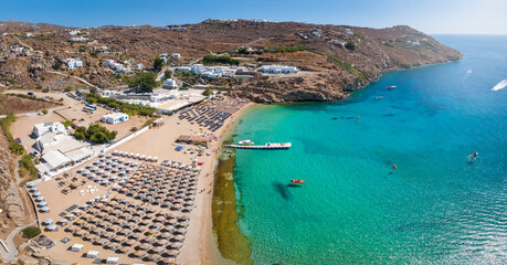 Aerial view of the beautiful Super Paradise Beach at Mykonos island, Cyclades, Greece, during a sunny summer day - obrazy, fototapety, plakaty