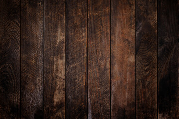 Dark vintage weathered wood planks background. Vignette grunge wooden texture.