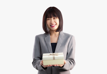 Young asian businesswoman in grey jacket suit giving gift box on white background.
