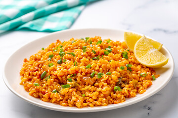 Traditional turkish bulgur pilaf with tomato sause in plate (Turkish name; meyhane pilavi)