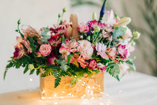 Beautiful pink flowers composition in the box close-up view. Festive decoration and background