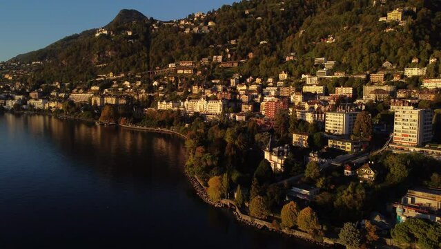 Fantastic aerial shot on the shore of Lake Leman, in the commune of Veytaux, in the canton of Vaud. You can see part of the city and during the golden hour.