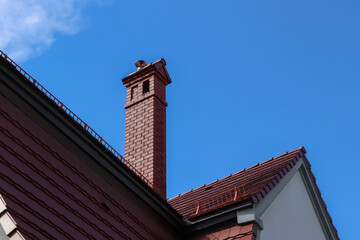 Beautiful house with brown roof against blue sky