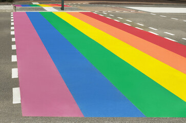 Bright rainbow LGBT pride flag on city road