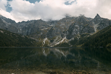Fototapeta na wymiar Landscape of a beautiful nature in the European mountains. Charming lake in front of mountain.