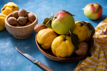 Autumn fruits apples and quinces fruits on blue background, top view, lifestyle food