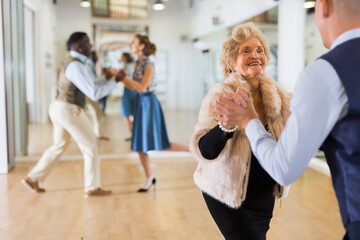 Mature woman at a group training in studio of dance