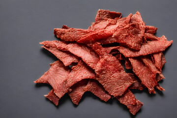 picture of beef jerky, dried meat, a food item with long shelf life - obrazy, fototapety, plakaty