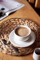 Coffee cup with milk in white ceramic cup. Lifestyle morning drink photo
