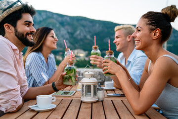 Leisure holidays vacation people and food concept. Happy friends having dinner at summer party
