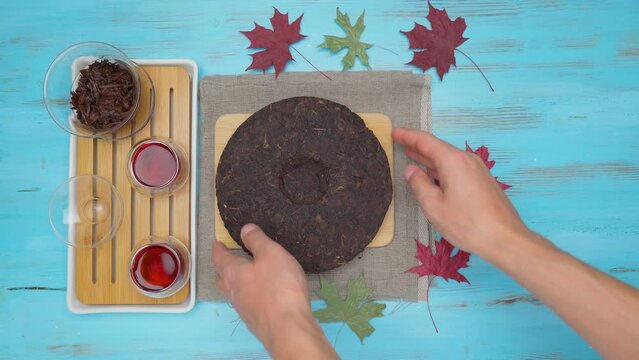 Black puer tea, dry pu erh tea leaves on blue background, tea ceremony. Flat lay.