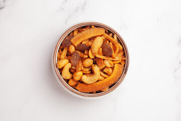 Close-up of  Shahi vrat or upvas or Fasting namkeen Mixture made from coconut,ground nuts, cashew, potato slice, peanut, Indian spicy snacks (Namkeen), served in ceramic bowl 