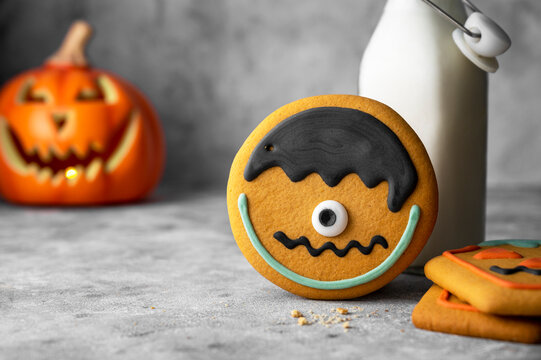 Halloween monster cookie with colorful glaze. Spooky ginger bread cookies for october autumn celebration